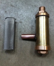 Bronze sea strainer body alongside its stainless steel filter basket